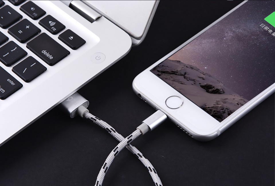 Iphone is connected by cable to laptop